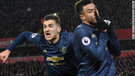 Jesse Lingard celebrates his equalizer for Manchester United at Anfield with Diogo Dalot (left). 