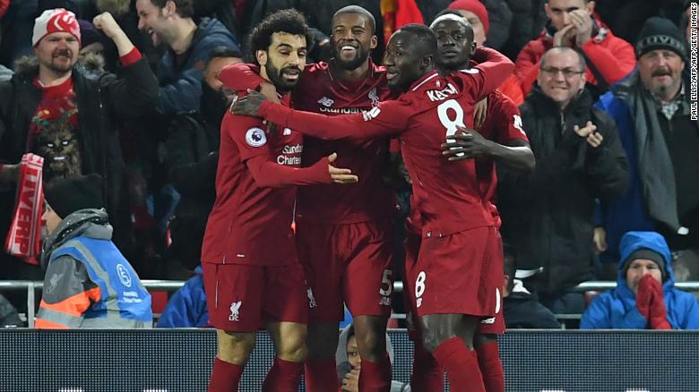 Liverpool&#39;s Senegalese striker Sadio Mane celebrates with his teammates after scoring the opener against Manchester United at Anfield. 