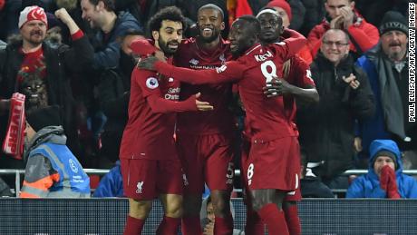 Liverpool's Senegalese striker Sadio Mane celebrates with his teammates after scoring the opener against Manchester United at Anfield. 