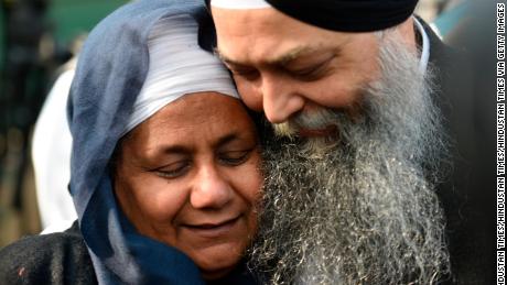 Nirpreet Kaur, an eyewitness to the 1984 Sikh massacre, is seen with AAP leader Jarnail Singh outside the Delhi High Court after  Kumar was sentenced to life imprisonment Monday.