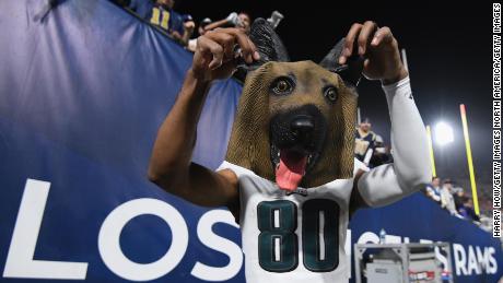 Jordan Matthews of the Philadelphia Eagles holds up a dog mask received from a fan after the team's big 30-23 win over the Los Angeles Rams.