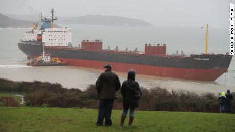 Local residents look out at the striken cargo ship on Tuesday afternoon. 