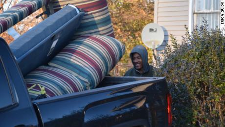 Volunteer Levi Lindsey loads furniture into Guido's pickup truck.