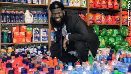 Principal Akbar Cook shows a portion of the donated detergent sent to New Jersey's West Side High School to support their free laundry room.