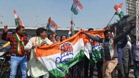 Indian Congress party supporters hold a Congress party flag as they celebrate in Ahmedabad on December 11, 2018 after local elections which saw the ruling BJP suffer major losses. 