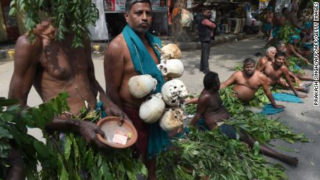 Indian farmers from the southern state of Tamil Nadu wear tree leaves and hold symbolic &#39;skulls&#39; as they take part in a protest in New Delhi on March 16, 2017. 