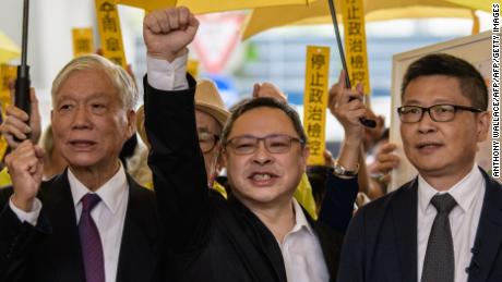 Baptist minister Chu Yiu-ming, 74, law professor Benny Tai, 54, and sociology professor Chan Kin-man, 59, shout slogans with supporters before entering the West Kowloon Magistrates Court in Hong Kong on November 19, 2018.