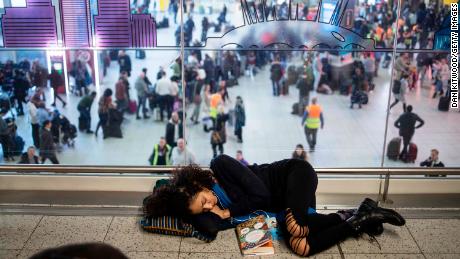 Stranded passengers sleeping on the floor.