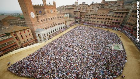 Twice a year, riders from 10 of the city's 17 districts, known as "contrade", race three times around Siena's central square to win the Palio.