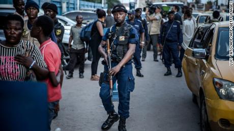 Police patrol outside the election commission headquarters in Kinshasa.