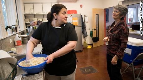 Rosa del Carmen Ortez-Cruz chats with volunteer Libby Johnson as she makes pupusas at Church of Reconciliation in Chapel Hill. The two women have become close friends since Rosa began living at the church in April.