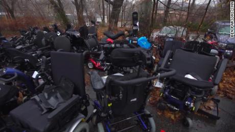 Donated wheelchairs stacked up behind Pavone's pawn shop will be utilized for parts.