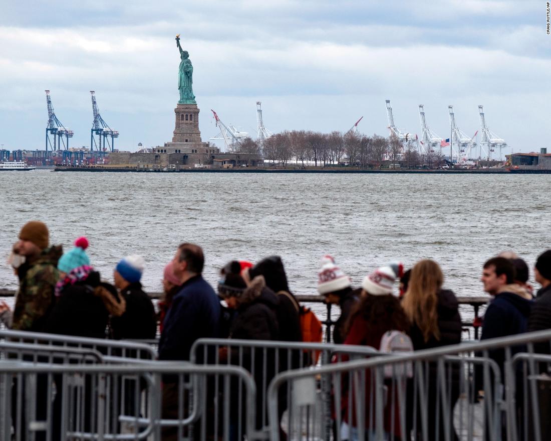 People line up to board a ferry to visit the Statue of Liberty on December 22. The national landmark remained open after New York Gov. Andrew Cuomo made funding available for it.