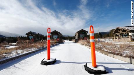 A lane is blocked to an unattended toll booth at Rocky Mountain National Park Saturday, December 22, in Estes Park, Colo. A partial federal shutdown has been put in motion because of gridlock in Congress over funding for President Donald Trump&#39;s  Mexican border wall. The gridlock blocks money for nine of 15 Cabinet-level departments and dozens of agencies including the departments of Homeland Security, Transportation, Interior, Agriculture, State and Justice.