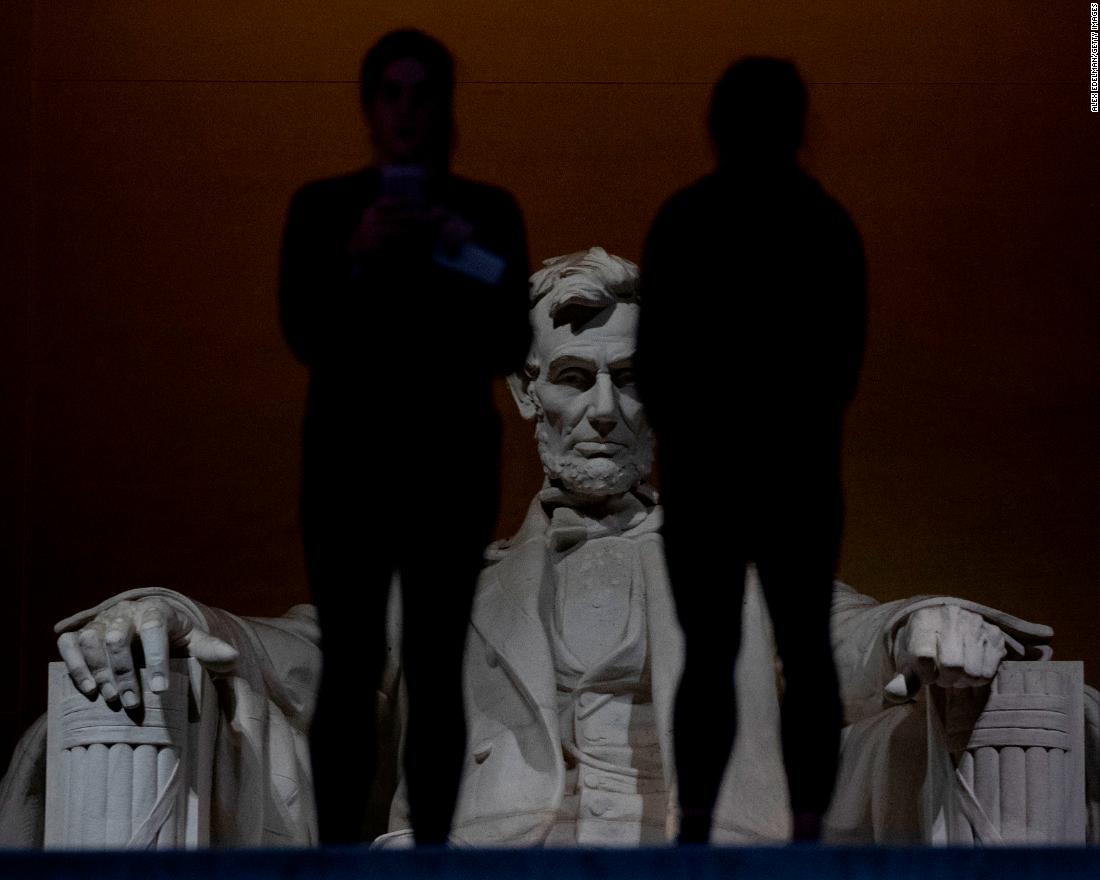 Two people stand in front of the Lincoln Memorial on Saturday, December 22. Many of the National Mall sights remained open despite the shutdown.
