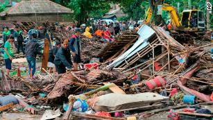 Residents inspect a house damaged by a tsunami in Carita, Indonesia, on Sunday, December 23, 2018, a day after the area was hit following an eruption of the Anak Krakatau volcano. 