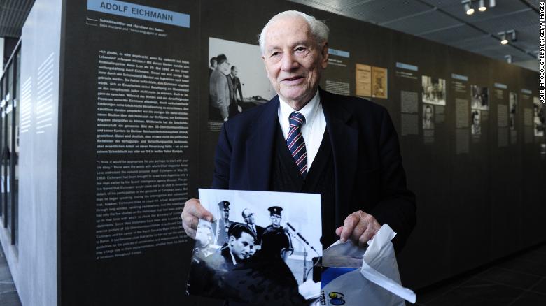 Bach holds a photo as he tours the 2011 exhibit &quot;Facing Justice -- Adolf Eichmann on Trial&quot; in Berlin. 