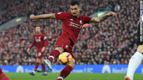 Liverpool's Croatian defender Dejan Lovren shoots to score the opening goal of the English Premier League match against Newcastle United at Anfield.