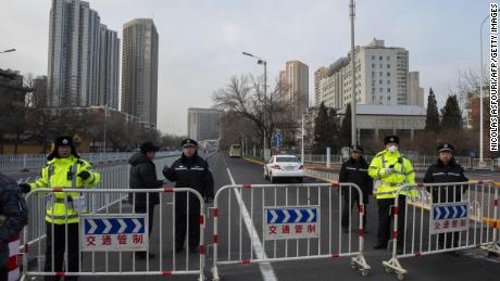 Police officers block streets in front of the number 2 intermediate people's court in Tianjin on December 26.