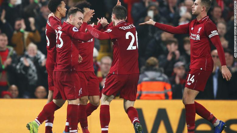 Xherdan Shaqiri (second left) celebrates his team&#39;s third goal in the 4-0 home win for Liverpool over Newcastle United.
