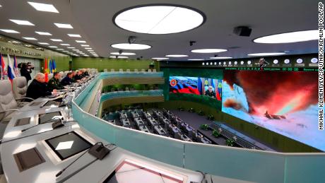 Russian Defense Minister Sergei Shoigu, fourth left, Russian President Vladimir Putin, fifth left, Chief of General Staff of Russia Valery Gerasimov, sixth left, and other top officials oversee the test launch of the Avangard hypersonic glide vehicle from the Defense Ministry's control room in Moscow on Wednesday. In the test, the Avangard was launched from the Dombarovskiy missile base in the southern Ural Mountains. The Kremlin says it successfully hit a designated practice target on the Kura shooting range on Kamchatka.