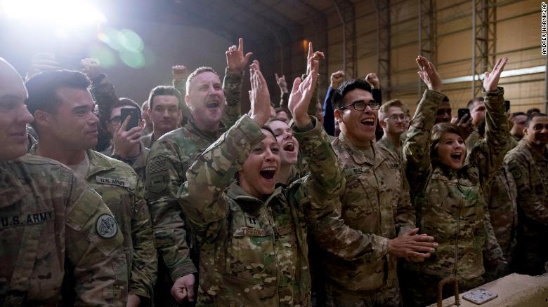 Members of the military cheer as President Donald Trump speaks at a hanger rally at Al Asad Air Base, Iraq, Wednesday, Dec. 26, 2018. President Donald Trump, who is visiting Iraq, says he has &#39;no plans at all&#39; to remove US troops from the country.  (AP Photo/Andrew Harnik)