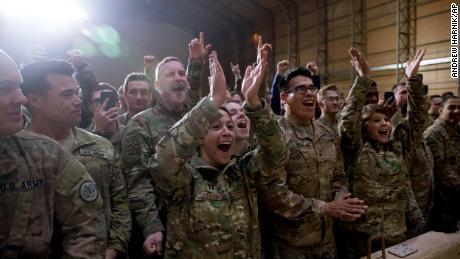 Members of the military cheer as President Donald Trump speaks at a hanger rally at Al Asad Air Base, Iraq, Wednesday, Dec. 26, 2018. President Donald Trump, who is visiting Iraq, says he has &#39;no plans at all&#39; to remove US troops from the country.  (AP Photo/Andrew Harnik)