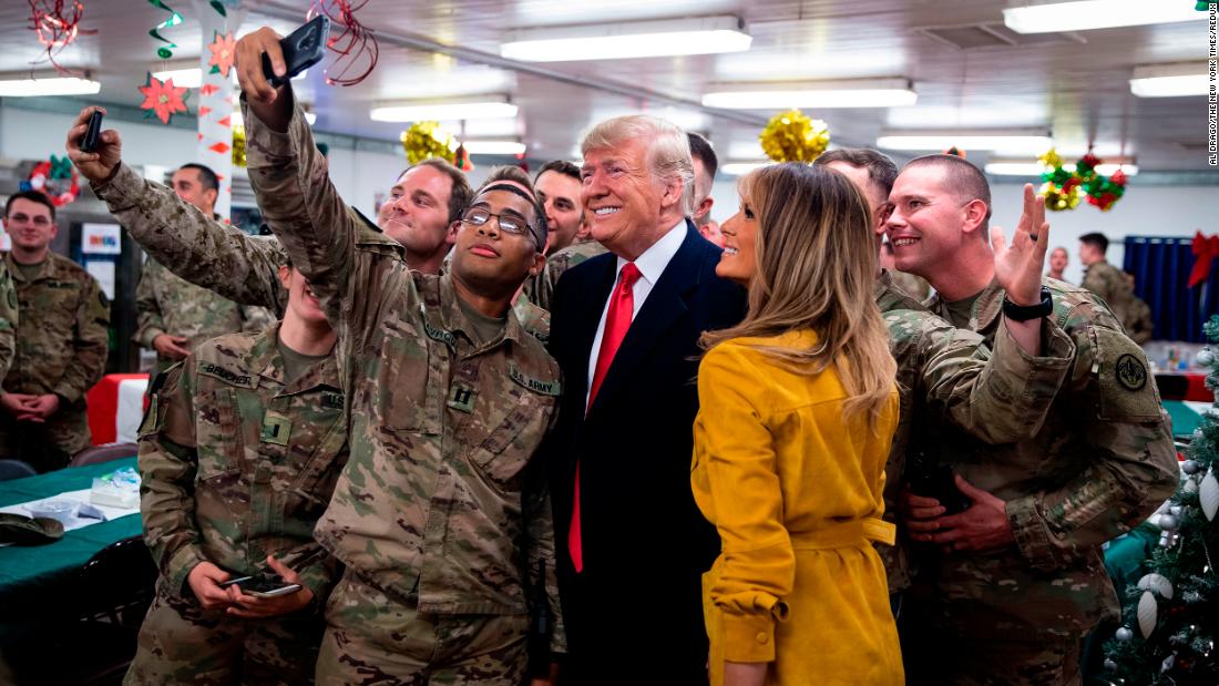 President Donald Trump and first lady Melania Trump greet military personnel at the dining hall during an unannounced visit to Al Asad Air Base in Iraq on Wednesday, December 26.