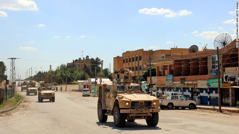 Vehicles of the US-led coalition battling the Islamic State group patrol the town of Rmelane in Syria&#39;s Hasakeh province on June 5, 2018. - The leading Syrian Kurdish militia said it would withdraw from Manbij, easing fears of a direct clash between NATO allies Washington and Ankara over the strategic northern town. Manbij is a Sunni Arab-majority town that lies just 30 kilometres (19 miles) south of the Turkish border, and where US and French troops belonging to the Western coalition against IS are stationed. (Photo by Delil souleiman / AFP) (Photo credit should read DELIL SOULEIMAN/AFP/Getty Images)