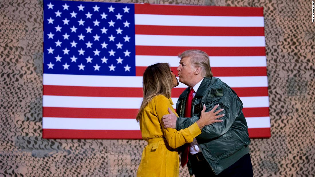 President Trump kisses the first lady during a hanger rally.