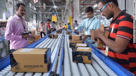 Employees of Amazon India scan packages at a new fulfilment centre on the outskirts of Bangalore.