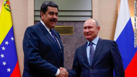 Russian President Vladimir Putin (R) shakes hands with his Venezuelan counterpart Nicolas Maduro during a meeting at the Novo-Ogaryovo state residence outside Moscow on December 5, 2018. (Photo by MAXIM SHEMETOV / POOL / AFP)        (Photo credit should read MAXIM SHEMETOV/AFP/Getty Images)