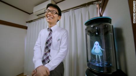 Kondo smiles next to his new bride Hatsune Miku.