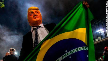 A Bolsonaro supporter in a Trump mask celebrates in the wake of October's election.