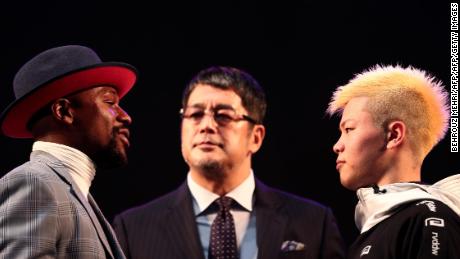 US boxing legend Floyd Mayweather Jr and kickboxer Tenshin Nasukawa of Japan pose on the stage during a weigh-in event at Saitama Super Arena.