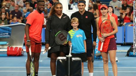 Serena Williams (second left) and Roger Federer are flanked by teammates Frances Tiafoe and Belinda Bencic as they line up before the start of their mixed doubles clash at the Hopman Cup. 