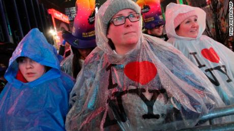 Darlene Freitas, of Ontario, Canada (center), attend New Year's Eve festivities in New York's Times Square on Monday.