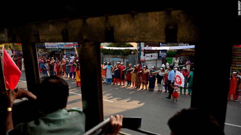 Women raise their hands to take a pledge to fight gender discrimination as they form part of a hundreds kilometer long &quot;women&#39;s wall&quot; in Thiruvananthapuram, in the southern Indian state of Kerala.