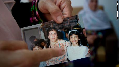 Fadwa Tlaib, an aunt of Rashida Tlaib points to a young Rashida in a 1987 picture with her mother, Fatima, and brother, Nader, at the family house in the West Bank village of Beit Ur al-Foqa on August 8, 2018.