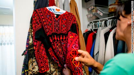 Rashida Tlaib shows her mother's thobe, a traditional Palestinian dress, in Detroit on August 10, 2018.