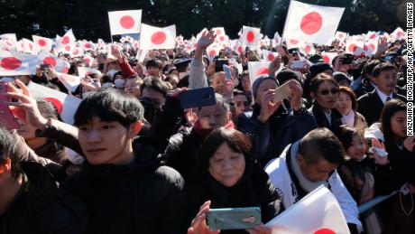 Well-wishers wave Japan's national flags during the greetings.