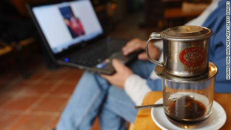 A man reads online news on his laptop at a coffee shop in downtown Hanoi (file photo).