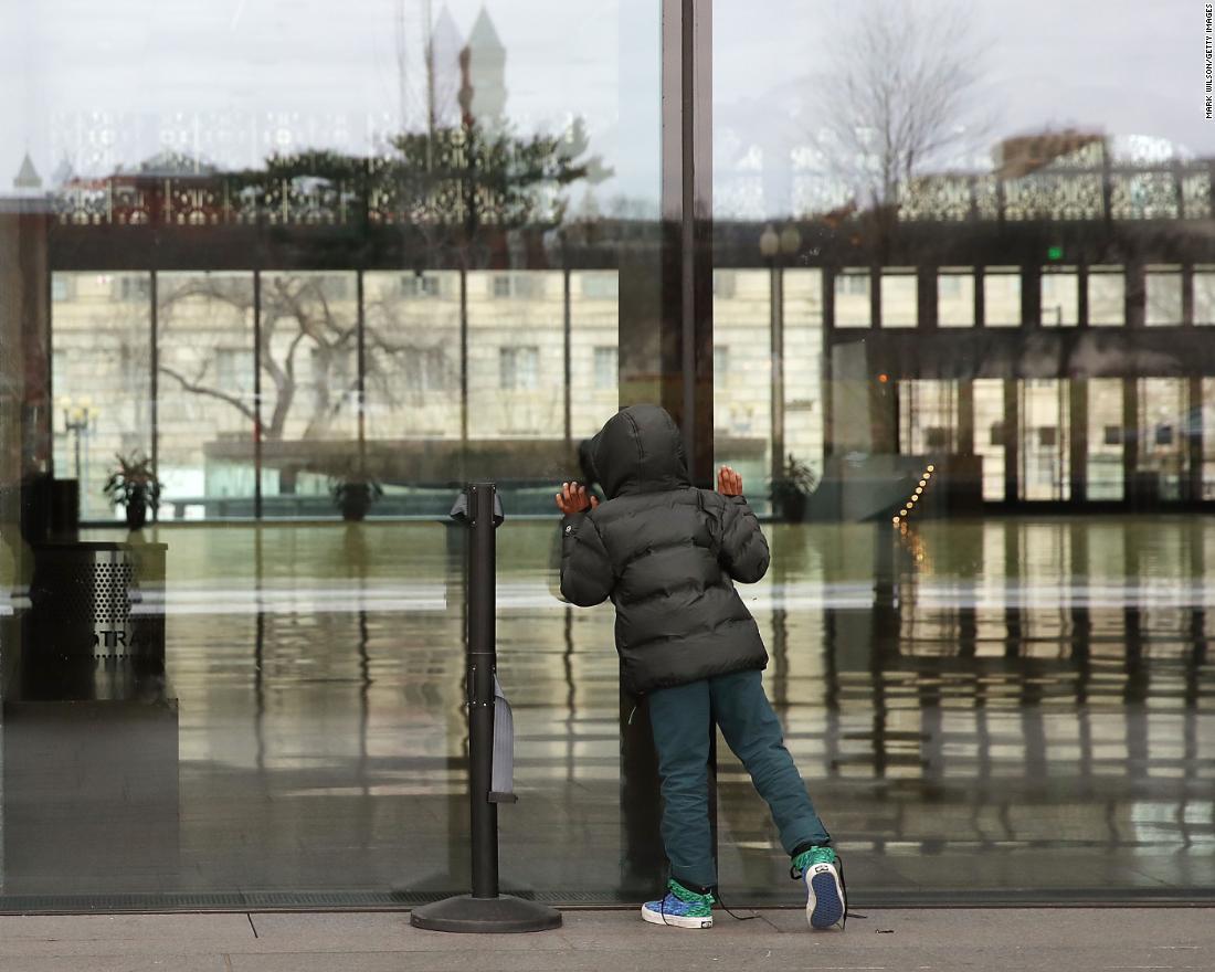 A child looks inside the National Museum of African American History, which was closed because of the shutdown.