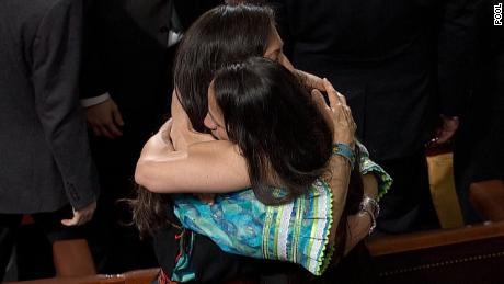 Democratic Reps. Deb Haaland and Sharice Davids embrace on the House floor.