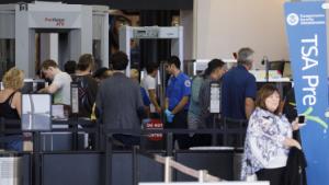 Travelers carry baggage for screening at a Transportation Security Administration (TSA) checkpoint at Los Angeles International Airport (LAX) in Los Angeles, California, U.S., on Thursday, Oct. 25, 2018. A new LAX policy will allow travelers to possess a small amount of marijuana inside the airport, and on planes, if the traveler is flying to a state where weed is legal. Photographer: Patrick T. Fallon/Bloomberg via Getty Images