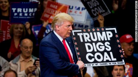 Republican presidential nominee Donald Trump  holds a sign supporting coal during a rally at Mohegan Sun Arena in Wilkes-Barre, Pennsylvania on October 10, 2016. 