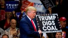 Republican presidential nominee Donald Trump  holds a sign supporting coal during a rally at Mohegan Sun Arena in Wilkes-Barre, Pennsylvania on October 10, 2016. 