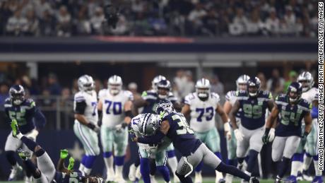 Dallas Cowboys' Allen Hurns suffers a leg injury when tackled by Seattle's Bradley McDougald.