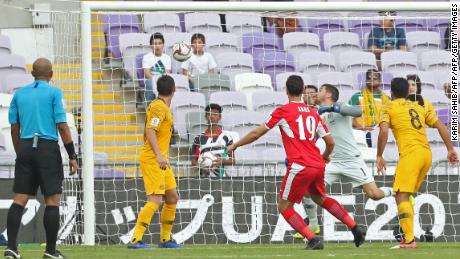 Jordan defender Anas Bani Yaseen scores with a header, the only goal of the game.