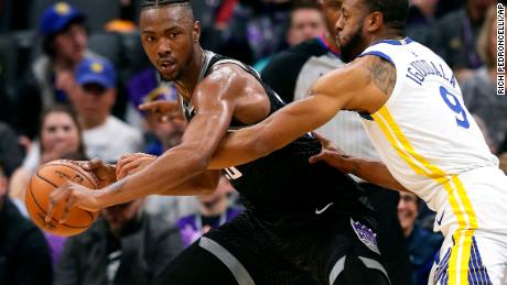 Golden State Warriors guard Andre Iguodala reaches in for the ball held by Sacramento Kings forward Harry Giles III.